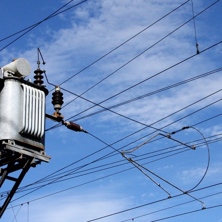 electricity cables against a blue sky